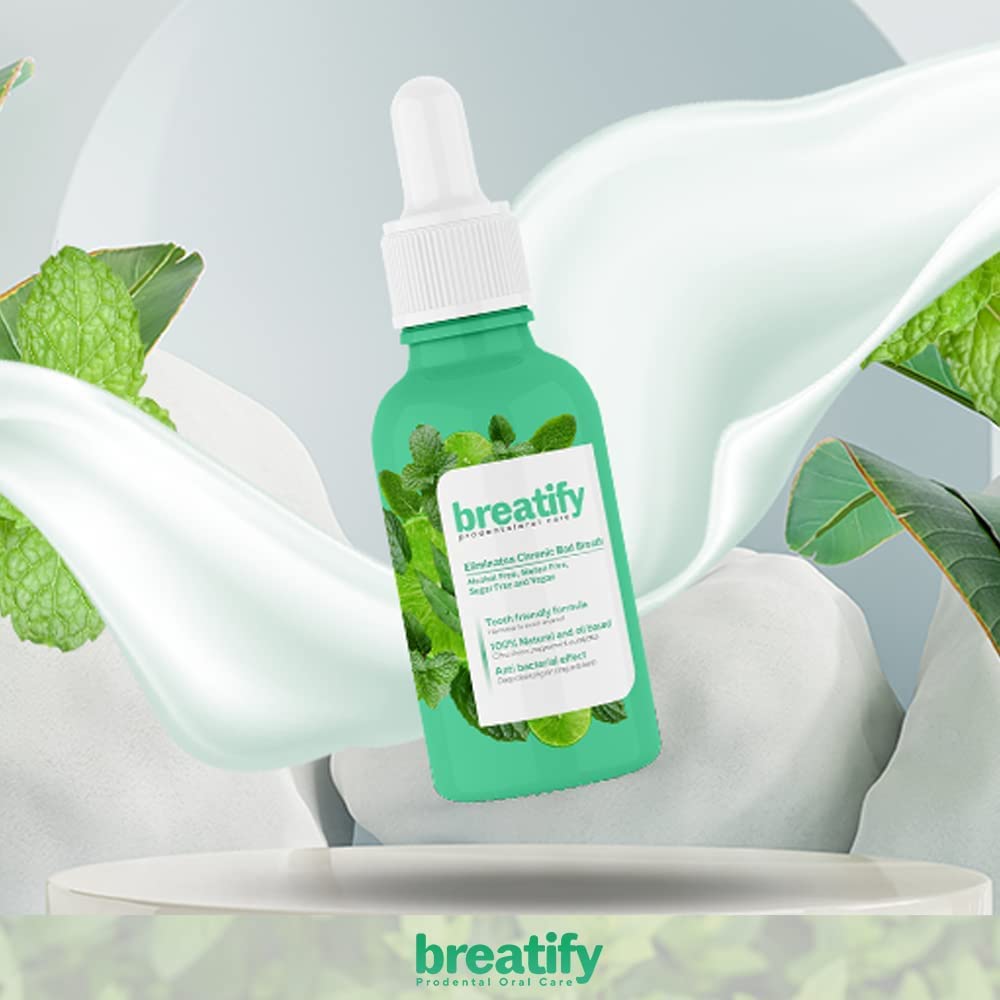 Frasco de Breatify con gotero, rodeado de hojas de menta y eucalipto